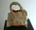 The Reincarnation of Bernie Madoff as a Snake Skin Purse with a Large Hole in the Bottom